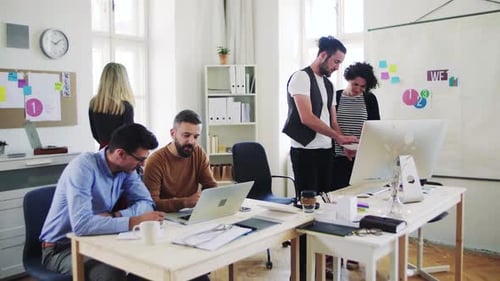 Young business team collaborating on a laptop in a modern office space