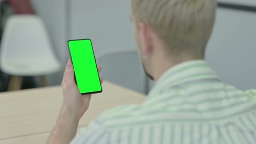 Man Holding Horizontal Smartphone with Green Screen