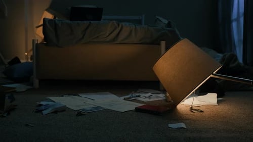 Messy, Dark Bedroom Interior with Lamp on Floor
