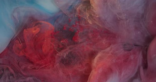 Abstract shot of swirling colorful inks in liquid