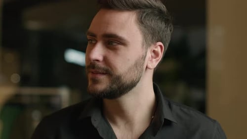 Handsome Man Smiles in an Indoor Setting