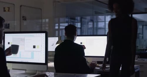 Office Workers Collaborating at Night