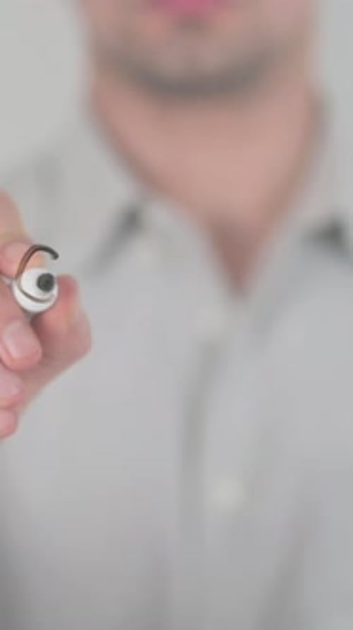 Man Writes Graphics on Glass with White Marker