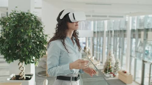 Woman Uses VR Headset in Modern Office