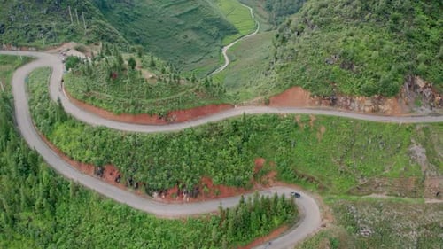 Aerial view of winding road through rice terraces, Vietnam.
