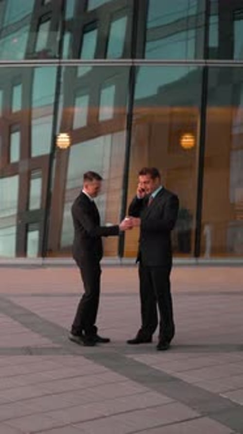 Men in Suits Walk and Talk Outside