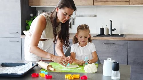 Woman and Child Baking Cookies Together