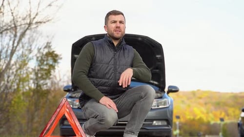 Frustrated Man on Road with Broken Car
