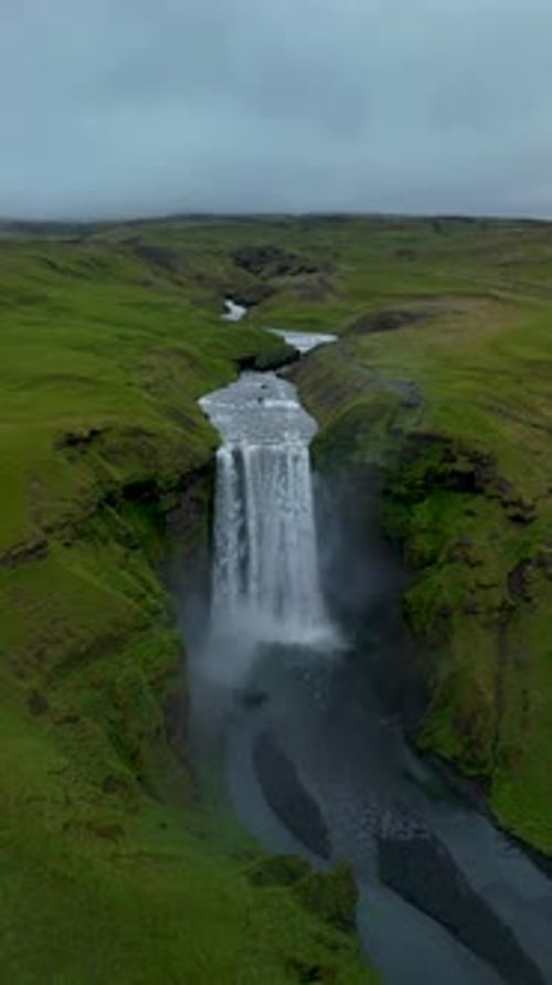 Skogafoss Waterfall Cascading Down Green Cliffs in Icelands Stunning Landscape