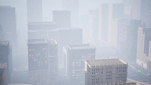 Aerial Cityscape Pan in Foggy Urban Environment