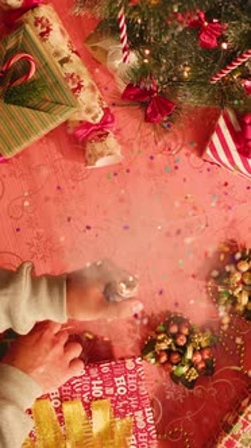 Hand Woman Decorating on Christmas Tree with Christmas Glow Lights Macro Decoration for New Year Eve