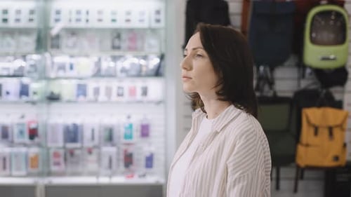 A Woman Walks Through an Electronics Store and Chooses Her Purchases