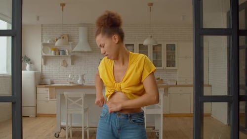 Irritated Black Woman Struggling to Fit Into Small Jeans After Gaining Weight