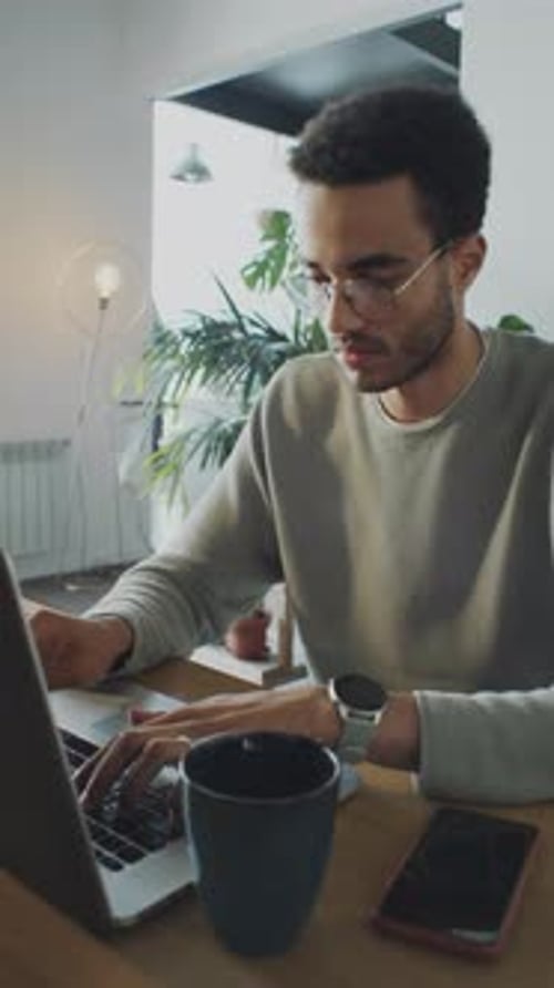 Man Working on Laptop in Home Office