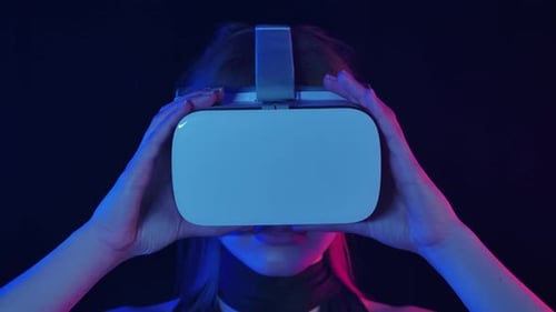 Woman Experiencing Immersive Virtual Reality With Headset