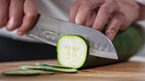 Chef slicing cucumber