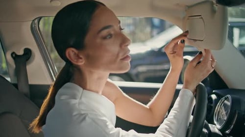 Brunette Looking Car Mirror Sitting Front Seat Close Up Woman Looking Camera