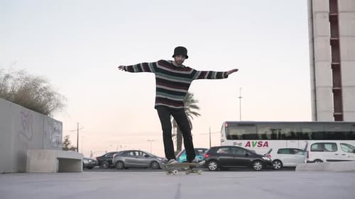 Skater Boy Practicing His Hobby in Square in the City