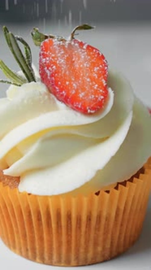 Cupcake with Strawberry and Rosemary Being Dusted with Sugar