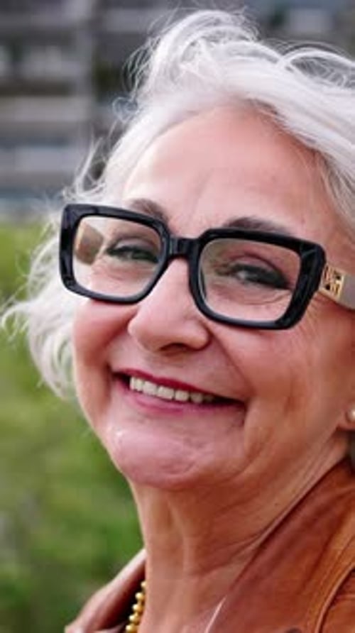 Portrait of a Healthy Happy Caucasian Senior Woman with Gray Hair Standing Outside at City