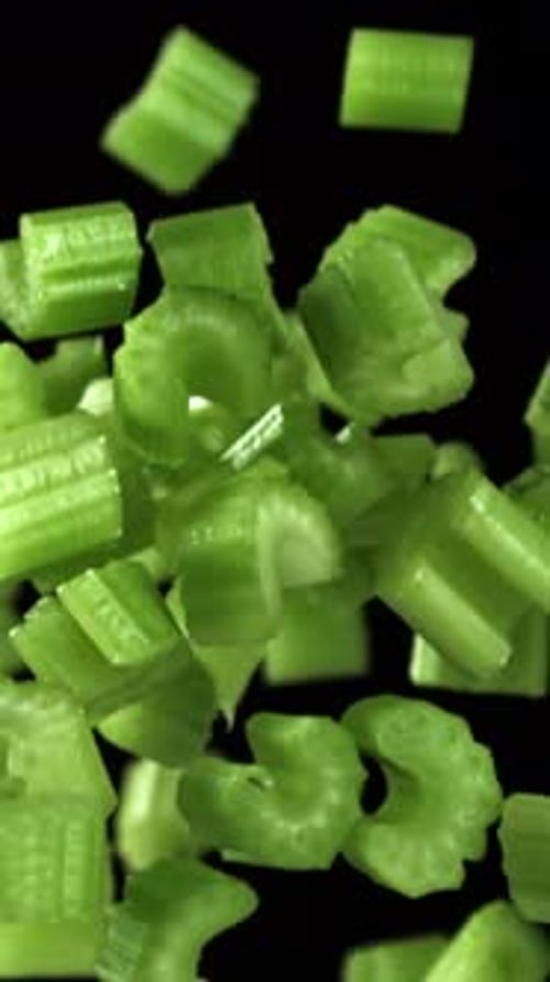 Sliced Pieces of Celery Rise and Fall on a Black Background Filmed on a Highspeed Camera at 1000 Fps