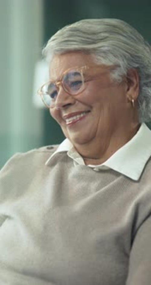 Smiling Senior Woman with Gray Hair and Glasses
