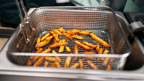 Crispy Sweet Potato Fries Deep Frying in Restaurant