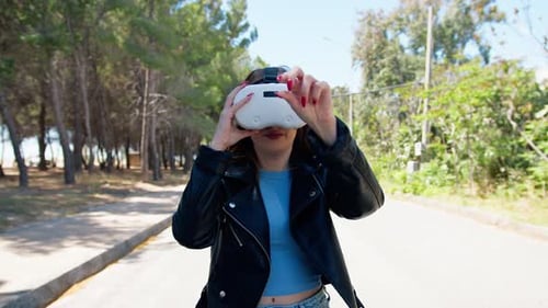Woman Wearing VR Headset in Park-like Setting