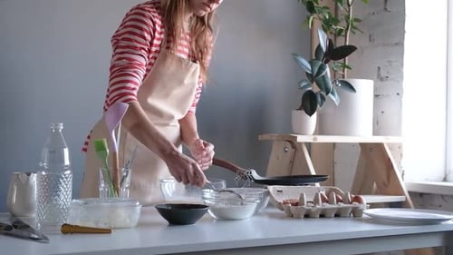 Adult Mixing Ingredients in Kitchen for Baking