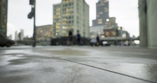 Urban Street View with Blurred Pedestrians and Buildings During Cloudy Day