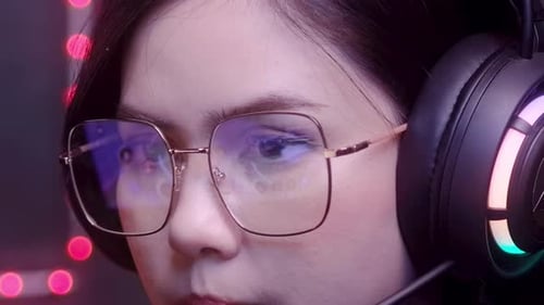 close up of professional Streamer and gamer wearing glasses playing online