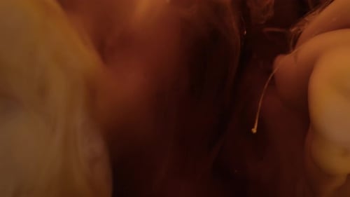 Milk pouring into coffee slow motion.