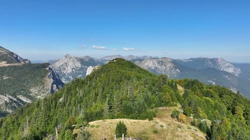 Flight over grass-covered mountain plains. Mountain range taken from above on a sunny autumn day. Me