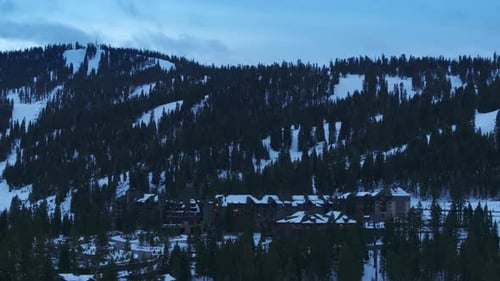 Aerial View of Snowy Mountain Resort in Pine Forest at Palisades Tahoe California USA