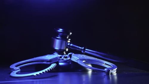 Handcuffs and Gavel with Dramatic Lighting