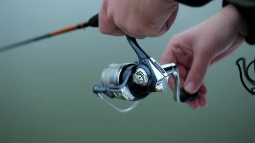 Hands Reel Fishing Rod by the Water