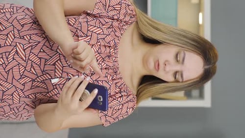 Woman Cleaning Nails While Using Her Phone
