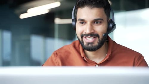 Cheerful Man with Headset Working in Office