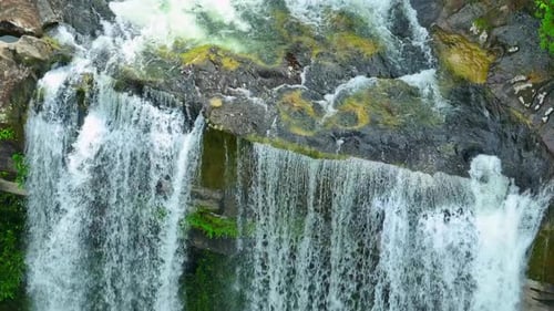 Aerial view over a waterfall in a beautiful tropical forest.