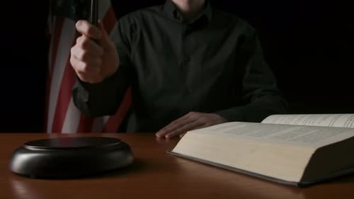 Gavel Strike by Judge in Dark Courtroom