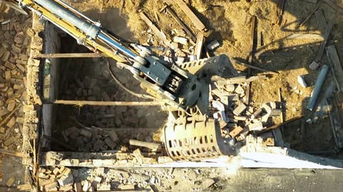 Hydraulic Excavator Demolishing Building from Above