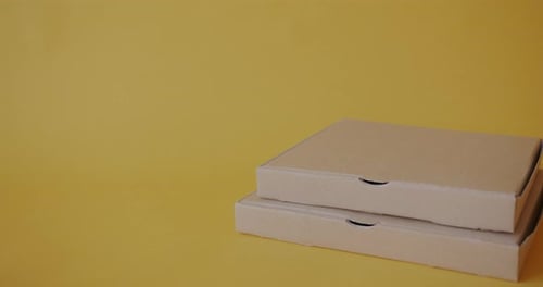Pizza Boxes and Coffee Cups on Yellow Background