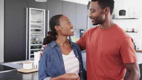 Happy Couple Embracing in Modern Kitchen