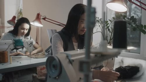 Female Tailor Works at Sewing Machine