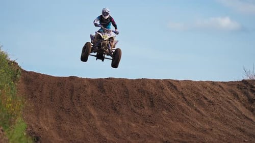 One Quad Racer Jumping From Slope on Dirt Road Trail in Extreme Slow Motion