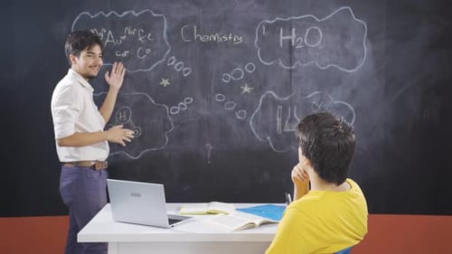 Chemistry Teacher Explaining Concepts to Student in Classroom