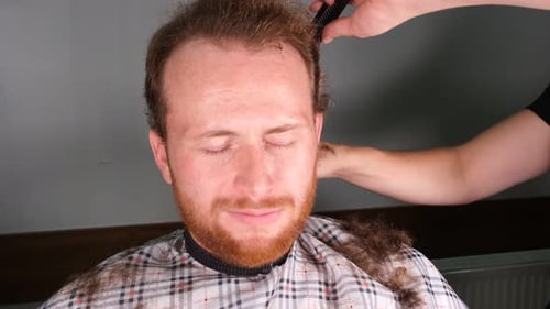 Adult Man Receiving Haircut Indoors