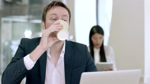 Entrepreneur working on laptop in cafe