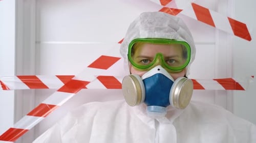 Person in Hazmat Suit with Respirator Mask