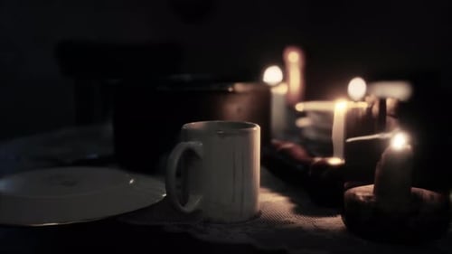 Flickering Candles Light Dark Table with Mug and Plate